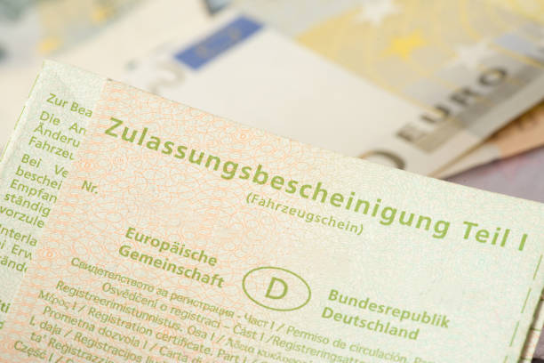 A vehicle license and euro banknotes Ein Fahrzeugschein und Euro Geldscheine car registration stock pictures, royalty-free photos & images
