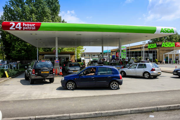 Vehicles waiting to fill up their vehicles at a gasoline filling station in Yeovil, Somerset UK stock photo