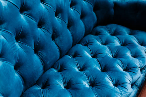 Velvet couch background texture with sunken buttons stock photo
