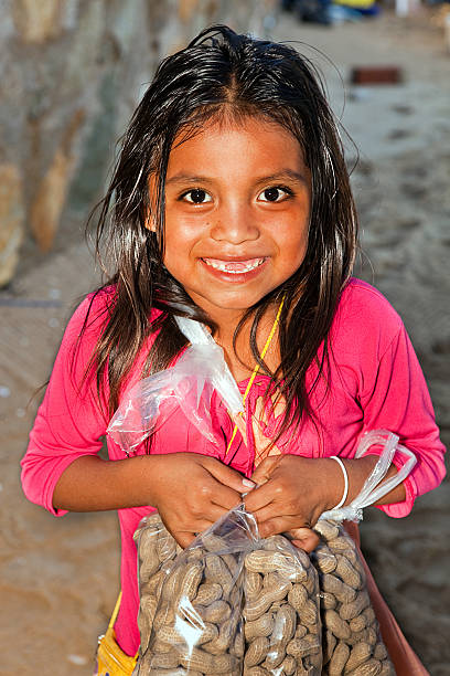 Vendor Girl 7 year old little girl selling peanuts on a beach in Mexico.  a.m. hot mexican girls stock pictures, royalty-free photos & images