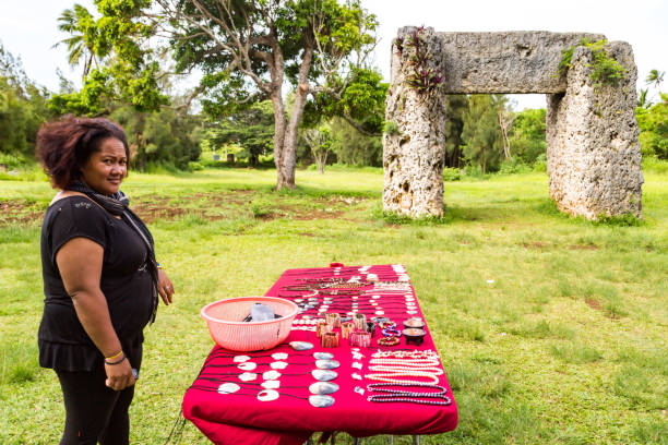 A vendor is selling souvenirs to tourists at Haamonga a Maui, Ha'amonga 'a Maui, or Burden of Maui site, a stone trilithon in the Kingdom of Tonga. Polynesia, Oceania stock photo