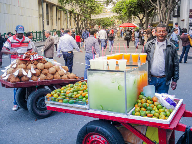 Vendors selling fresh coconuts and mandarins in the streets stock photo