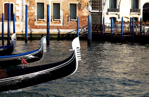 three Venetian gondolas sailing the waters of the Grand Canal in Venice