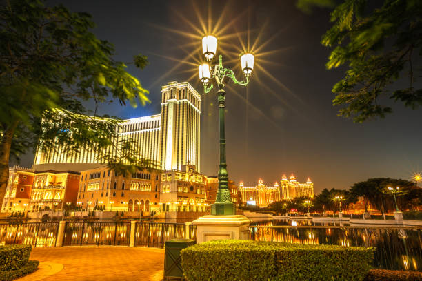 Venetian Macao by night Macau, China - December 9, 2016: iconic gold Venetian Resort and Casino at night seen from Galaxy Cotai Strip. Gambling tourism is Macau's biggest source of revenue, making up half of the economy the venetian macao stock pictures, royalty-free photos & images