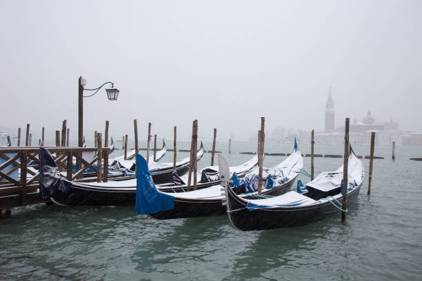 Venice in snow with gondolas on St. Mark square stock photo