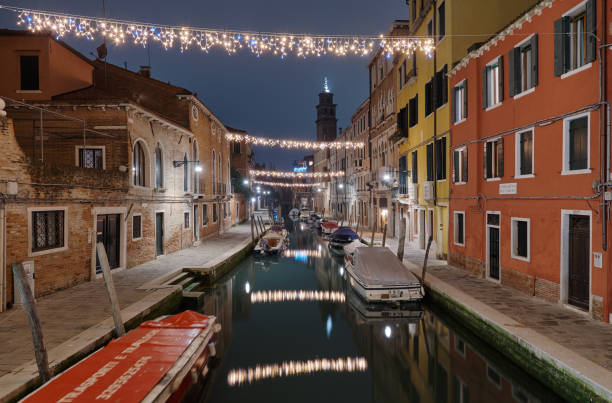 Venice, Italy January 2 , 2020.Colorful decorated alley with christmas lights view fromthe  Ponte dei Pugni bridge stock photo