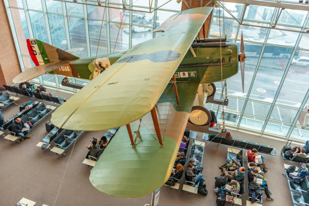 Venice Marco Polo Airport, a view of the interior with a plane. Venice, Italy - February 7, 2016: Venice Marco Polo Airport, hall of departures, a view of the interior with a plane. Passengers expect the announcement of the beginning a boarding into the plane. museums stock pictures, royalty-free photos & images