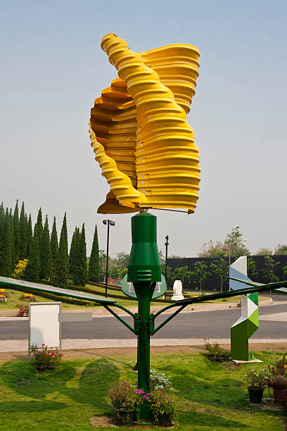 Vertical axis wind turbines in park Vertical-axis wind turbines (VAWTs) are a type of wind turbine where the main rotor shaft is set vertically and the main components are located at the base of the turbine. vertical axis wind turbine stock pictures, royalty-free photos & images