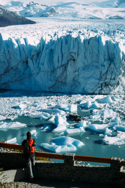 Vertical high angle shot of a person looking at the icebergs in the sea in Argentina stock photo