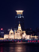 Shanghai, China - Dec. 18, 2021: Vertical illumination of buildings on the Bund at night in Shanghai city.