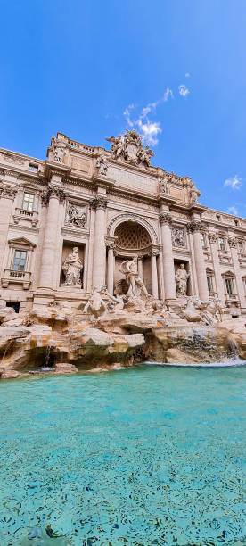 Vertical view of the sunny Trevi Fountain in the city of Rome in Italy stock photo