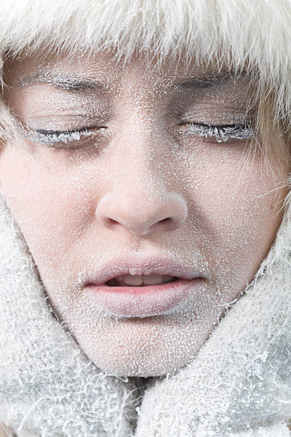 Very cold weather. Chilled female face covered in ice. stock photo