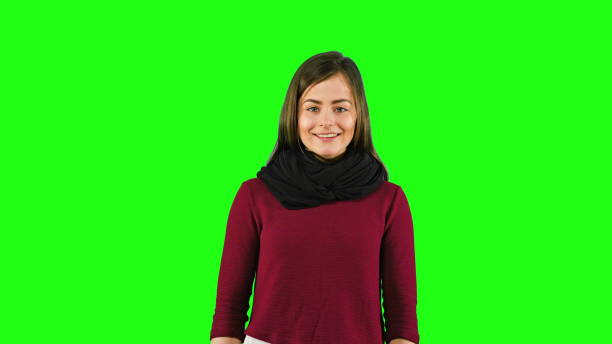 A Very Happy and Emotional Woman Smiling A young and happy overjoyed woman smiling against a green background. Medium shot medium shot stock pictures, royalty-free photos & images
