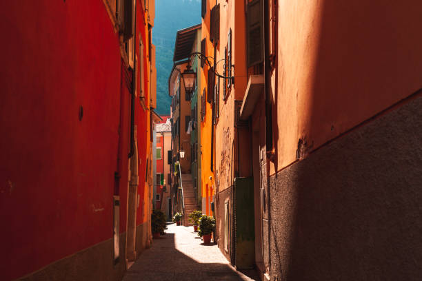 Very narrow street in Riva del Garda in Italy with interesting play of light and shadow stock photo