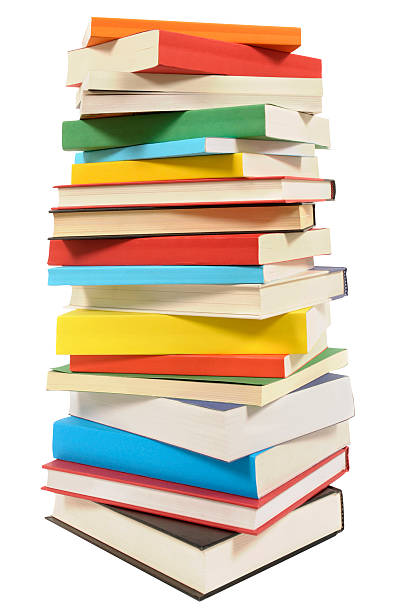 very tall pile of books isolated on white background - book tower stockfoto's en -beelden
