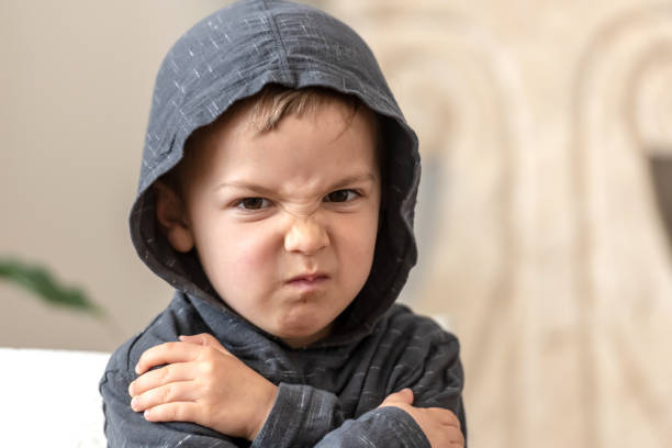 very upset three years old boy looking at the camera very upset three years old boy looking at the camera wearing a hoodie brat stock pictures, royalty-free photos & images