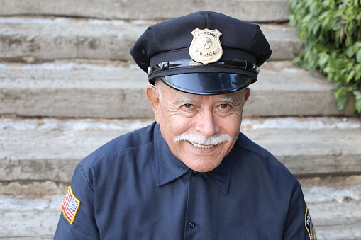 Veteran police officer with a mustache.