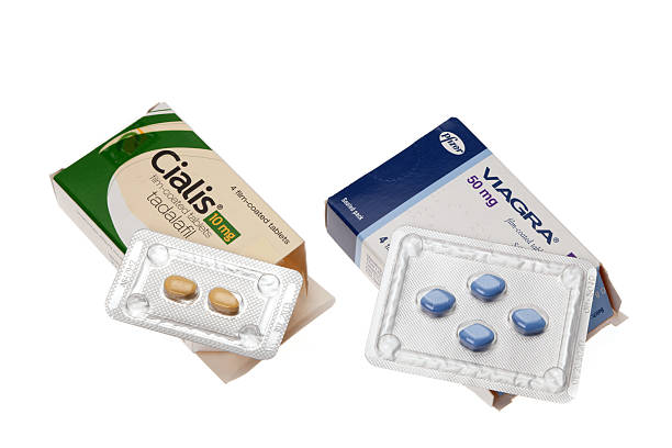 Viagra and Cialis - Erectile dysfunction tablets Folkestone, United Kingdom - May 6, 2011: Viagra and Cialis - Erectile dysfunction tablets.  A box of each tablets opened and displaying the contents.  A white background was used to isolate the subjects. anti impotence tablet stock pictures, royalty-free photos & images