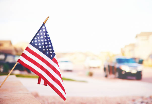 Vibrant American flag in summer sunshine with defocused street