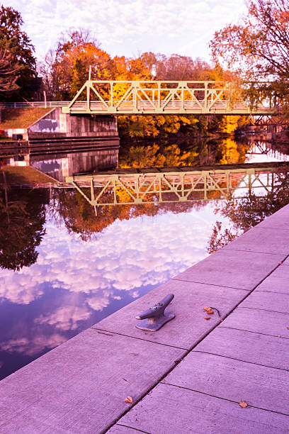 Photo of Vibrant Bright Autumn Morning Erie Canal Foliage and Bridge Reflections
