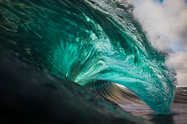 Vibrant emerald green ocean wave stock photo