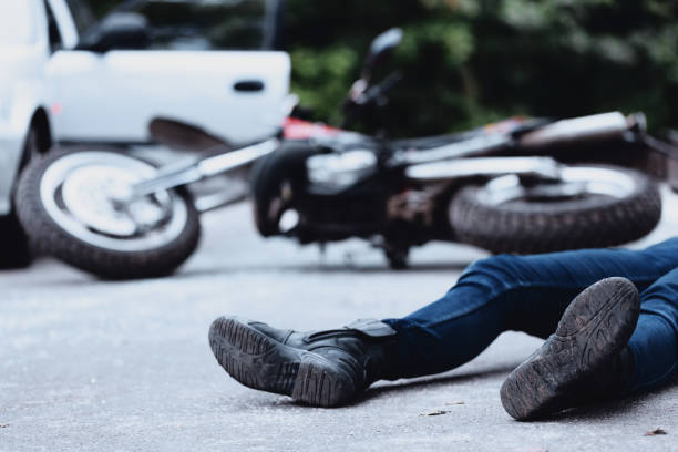 Victim of motorbike accident Victim of a motorbike accident lying on the street unconscious crash stock pictures, royalty-free photos & images