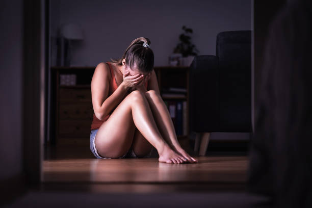 Victim of sexual harassment, domestic violence or abuse. Young sad woman crying and sitting on the floor at home. Ashamed, scared or lonely lady suffering emotional pain. Victim of sexual harassment, domestic violence or abuse. Young sad woman crying and sitting on the floor at home. Ashamed, scared or lonely lady suffering emotional pain. Stress, trauma or sorrow. victim stock pictures, royalty-free photos & images