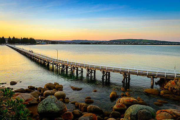 Victor Harbor foot bridge at sunset View at the Victor Harbor foot bridge at sunset from the Granite Island, South Australia south australia stock pictures, royalty-free photos & images