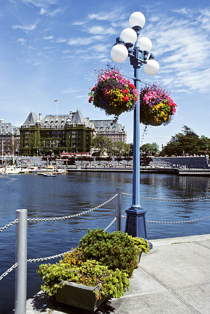 Victoria Inner Harbor and the Empress Hotel The historic Empress Hotel was photographed from across the Inner Harbor in Victoria, British Columbia, Canada. jeff goulden people stock pictures, royalty-free photos & images