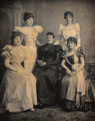 Victorian Portlait of Mother and 4 daughters who are wearing long formal dresses. Circa 1880 in Birmingham, in England