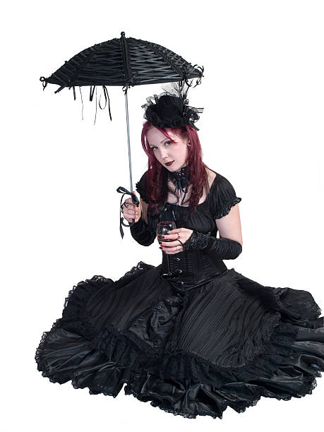 Victorian Gothic Girl - Seated with Parasol and Wine stock photo