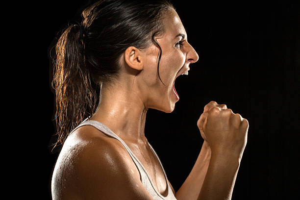 Victorious scream shout celebration athlete victory winning female champion stock photo