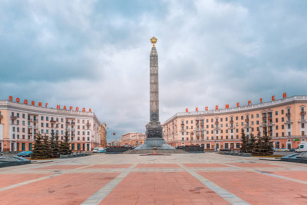 Victory Square in Minsk, Belarus Monument in honor of the victory in World War II at Victory Square in Minsk, Belarus. Panorama. Red letters read Heroic deed of the people is immortal minsk stock pictures, royalty-free photos & images
