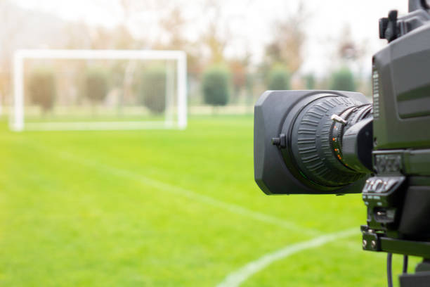 video camera put on the back of football goal for broadcast on TV sport channel. football program can't editing in studio. camera man is importance to catch moment of player. stock photo