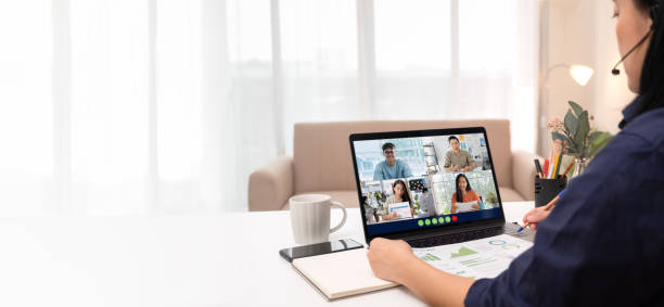 Video conference meeting from home.asian woman present business chart project on teleconference collaboration with colleagues with laptop at home.banner space for display of content stock photo