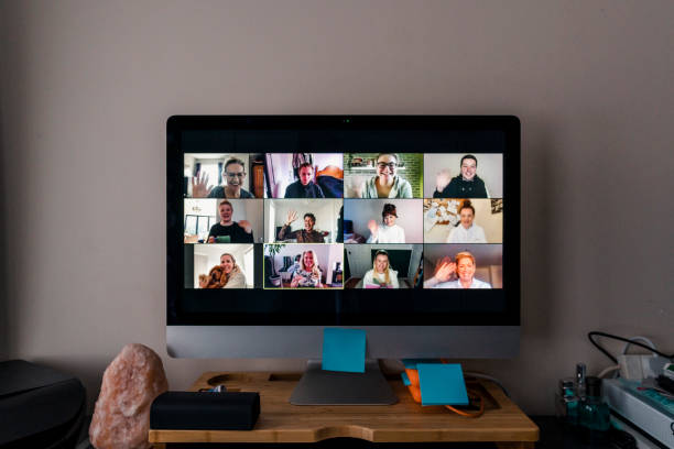 Video Conference Image of a team conference call on a computer screen in a home office. conference call stock pictures, royalty-free photos & images
