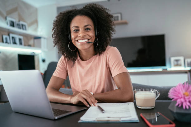 Video Conference Beautiful afro-american woman using laptop at home for online video call hands free device stock pictures, royalty-free photos & images