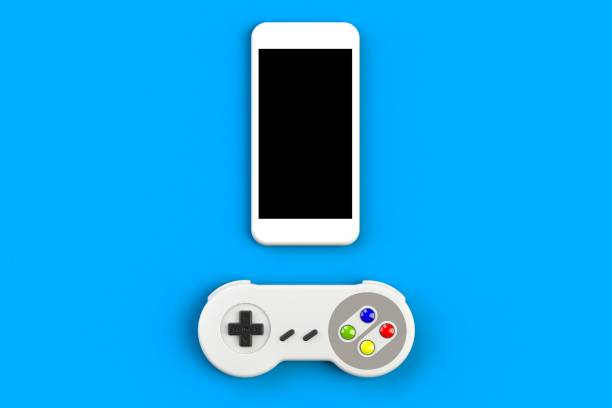 Video game console GamePad. Gaming concept. Top view retro joystick with smartphone isolated on blue background, 3D rendering stock photo