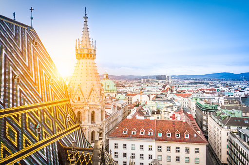 Aerial view over the rooftops of Vienna from the north tower of St. Stephen's Cathedral including the cathedral's famous ornately patterned, richly colored roof created by 230,000 glazed tiles, Austria