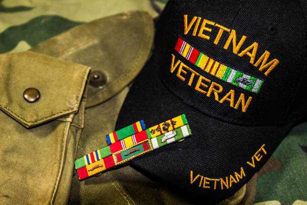 Vietnam Veterans Hat, Service Ribbons & Pouches Vietnam Veterans Hat, Service Ribbons & Pouches On Camouflage Uniform veteran stock pictures, royalty-free photos & images