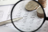 istock View at financial details in table thru magnifying glass 1316693862