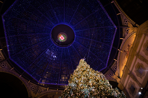 view from below of the Galleria Vittorio Emanuele in Milan with Christmas lights and decorations