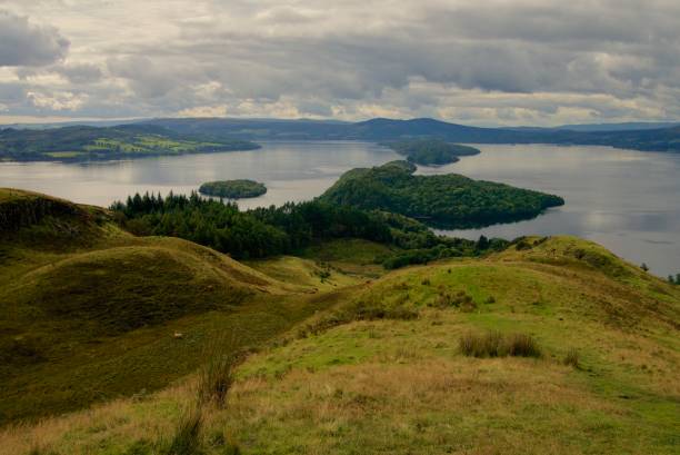 View from Conic Hill of Loch Lomond Looking down from Conic Hill, Stirling, Scotland. Looking over Loch Lomond with the Islands of Inchcailloch, Torrinch and Clairinsh visible. skeable stock pictures, royalty-free photos & images