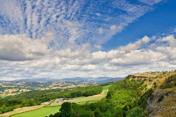 A view from Scout Scar looking across the Lyth Valley to the distant Lake District. A view from Scout Scar looking across the Lyth Valley to the distant Lake District hills. The sky is enhanced by Cumulus and Altocumulus clouds. altocumulus stock pictures, royalty-free photos & images