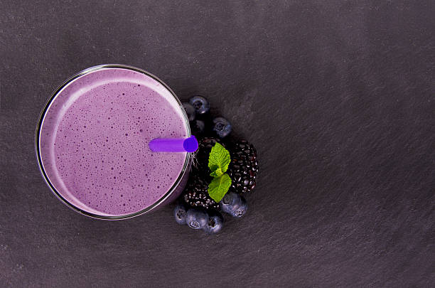 Glass of berry smoothie, isolated on slate plate. Top view.