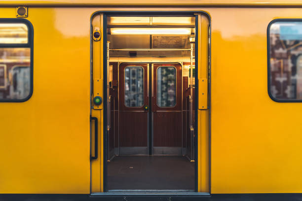 view into old yellow wagons of traditional berlin metro train old yellow wagon of traditional berlin metro train with doors open at subway station railroad station photos stock pictures, royalty-free photos & images