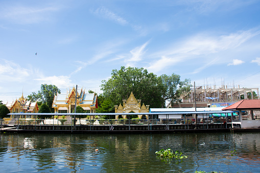 View landscape of Khlong Damnoen Saduak canal river and water flowing with cityscape countryside rural at Wat Thammachariya Phirom temple at Ban Phaeo city on June 8, 2022 in Samut Sakhon, Thailand