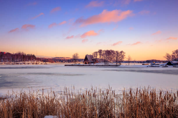 View of a frozen lake during sunrise in winter season stock photo