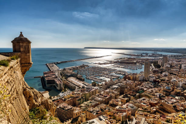 View of Alicante city and marina from Castel Santa Barbara From atop mount Benacantil, a view of part of historic Castel Santa Barbara, Alicante marina and old city. alicante province stock pictures, royalty-free photos & images