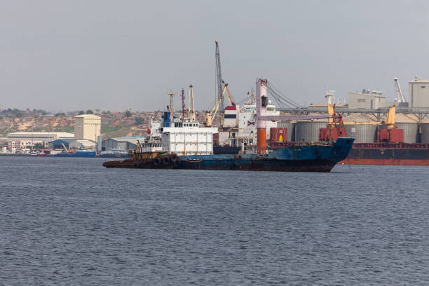 View of an oil tanker, ready to dock at the Port of Luanda, port logistics center with containers, equipment and machinery in the background, Luanda , Angola stock photo